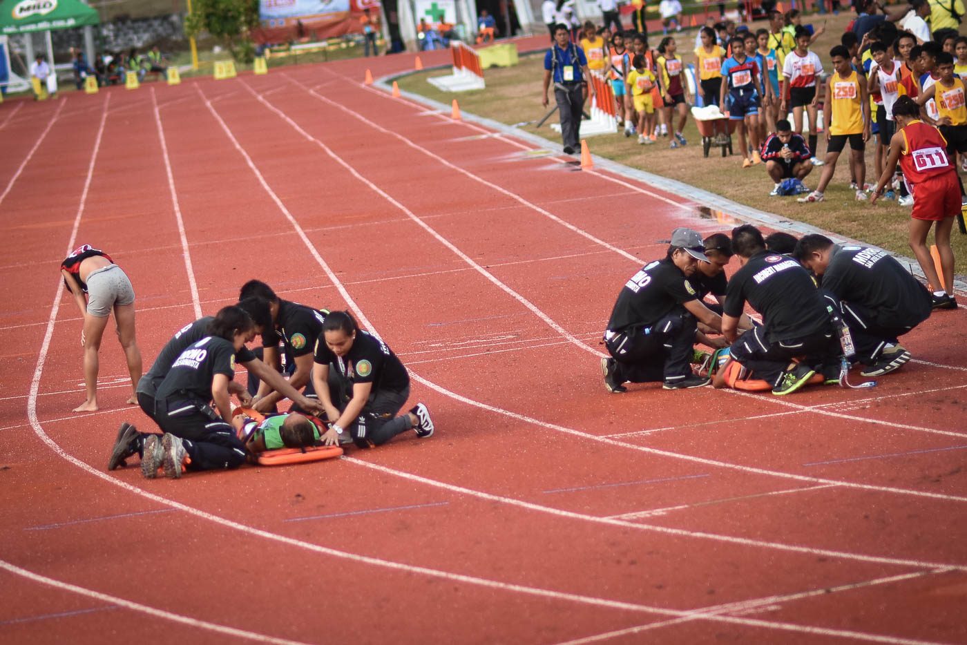 MORE INJURIES. Medical rescue teams attend to athletes collapsing at the finish line during the track and field event at the EBJ Sports Stadium in San Jose Buenavista. Photo by LeAnne Jazul/Rappler  