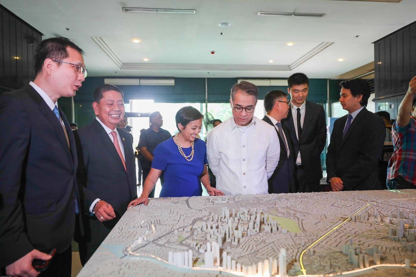 ONE STEP AHEAD. Makati Mayor Abby Binay smiles as she views the routes of the Makati Subway using a scale model. She is joined by Philippine Infradev President and CEO Antonio Tiu, City Administrator Claro Certeza and Makati 2nd District Representative Luis Campos. Photo from the Makati City government  