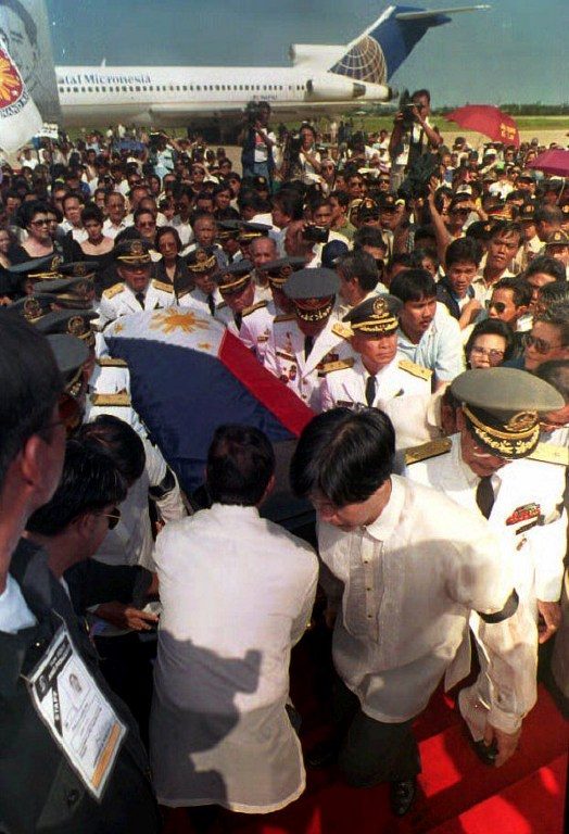 ARRIVAL. The flag-draped coffin of former Philippine President Ferdinand Marcos is carried to a stage by his son Ferdinand Marcos Jr (R wearing black armband) and retired military generals at the Laoag airport in the Philippines, September 7, 1993, after being flown from Honolulu. Photo by Romeo Gacad/AFP  