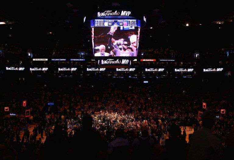 CELEBRATION. A general view of ORACLE Arena as LeBron James of the Cleveland Cavaliers holds the Bill Russell NBA Finals Most Valuable Player Award. The Cavs return the favor of celebrating a title on the Warriors' home floor. Ronald Martinez/Getty Images/AFP 