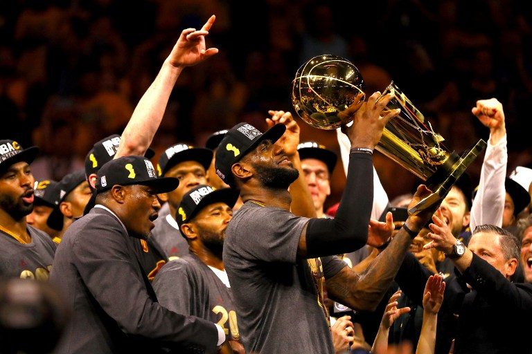SWEET VICTORY. It was a long time coming – but LeBron James of the Cleveland Cavaliers holds the Larry O'Brien Championship Trophy after defeating the Golden State Warriors. He finally fulfills his promise to bring a title to the city of Cleveland. File Photo by Ezra Shaw/Getty Images/AFP  