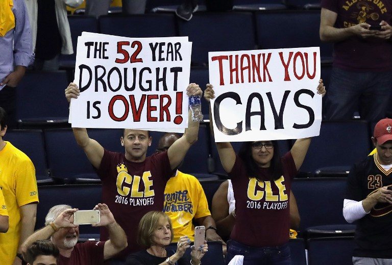 DROUGHT OVER. Cleveland Cavaliers fans hold signs after the Cavaliers defeated the Golden State Warriors in Game 7 of the 2016 NBA Finals. Ronald Martinez/Getty Images/AFP 