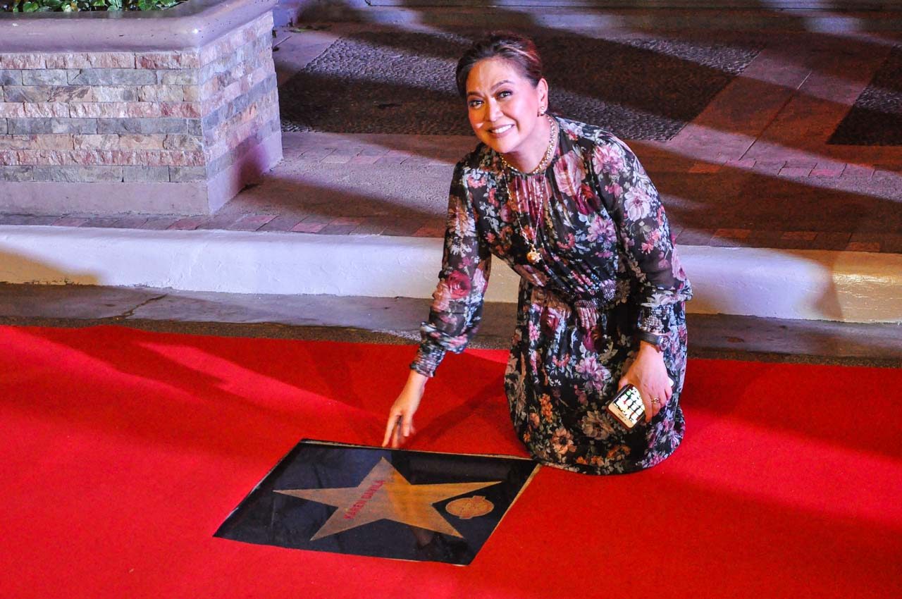 Karen Davila poses next to her star 