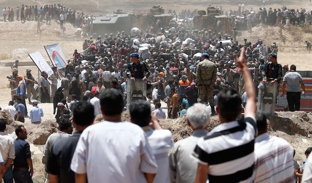 Kurds battle ISIS on Syria border as Turkey blocks refugees