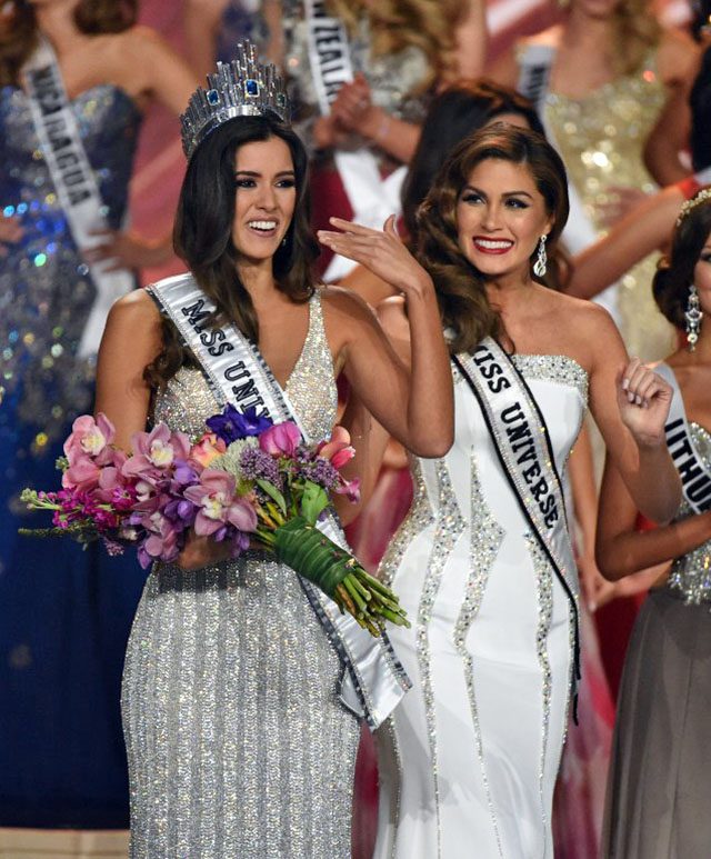 Miss Colombia Paulina Vega (L) is crowned Miss Universe 2014 by Miss Universe 2013 Gabriela Isler (R) during the 63rd Annual MISS UNIVERSE Pageant at Florida International University on January 25, 2015 in Miami, Florida. Photo by AFP/Timothy A. Clary 