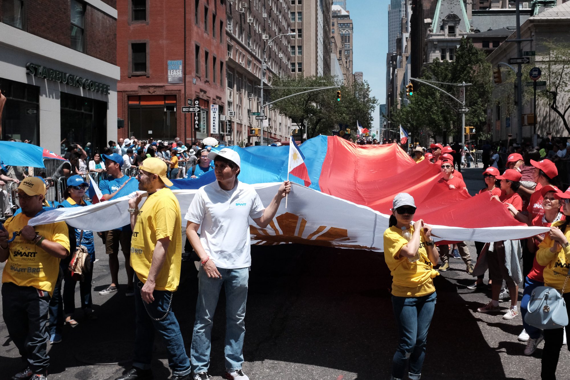 COMMUNITY. Filipinos paraded a huge Flag during the parade.  