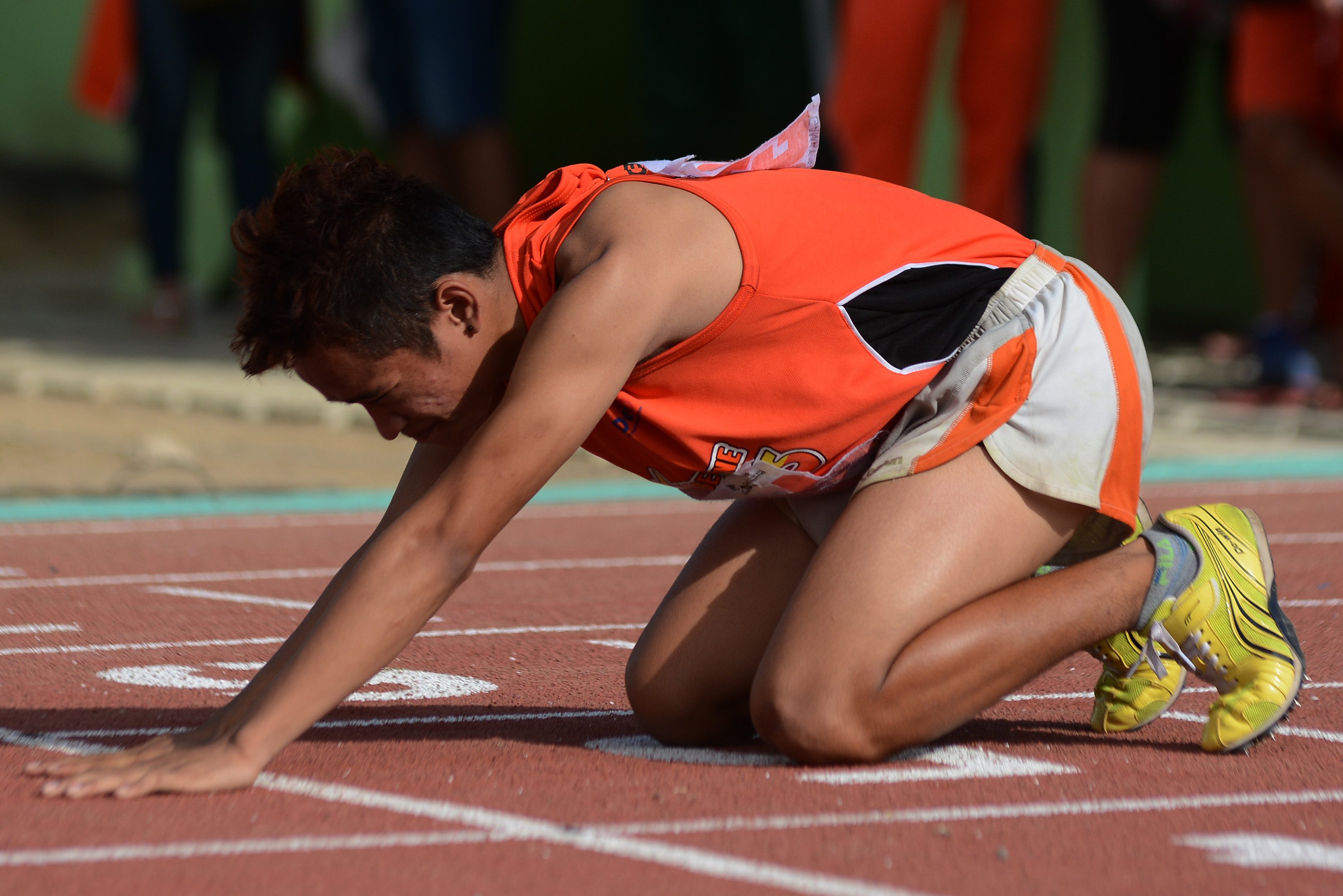 EXHAUSTED. An athlete is exhausted after 200-meter run. Photo by Roy Secretario/ Rappler 