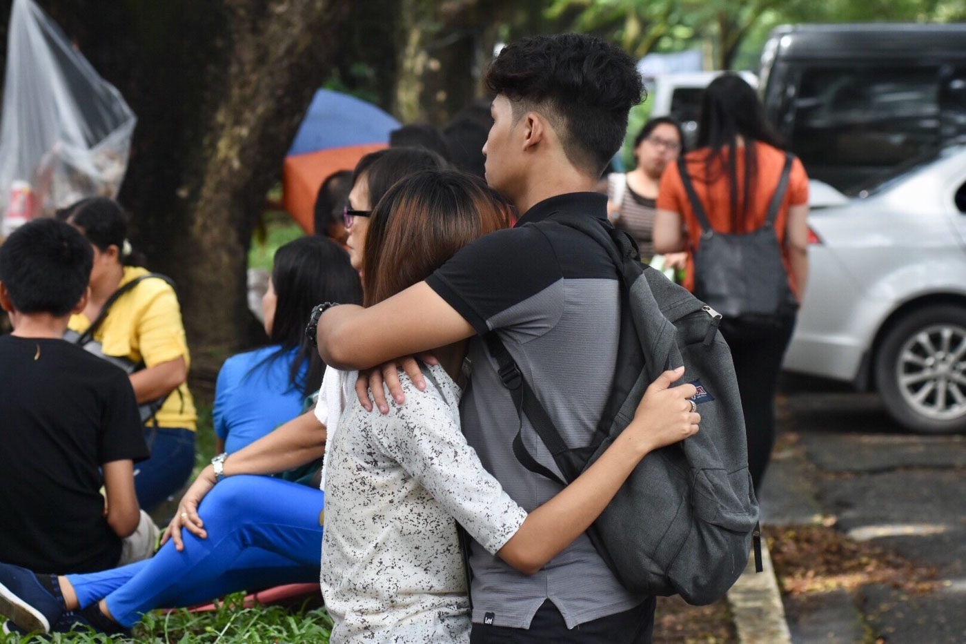 COMFORT. Tight hugs meet every UPCAT taker walking out of Palma Hall, followed by 'You did it!'   