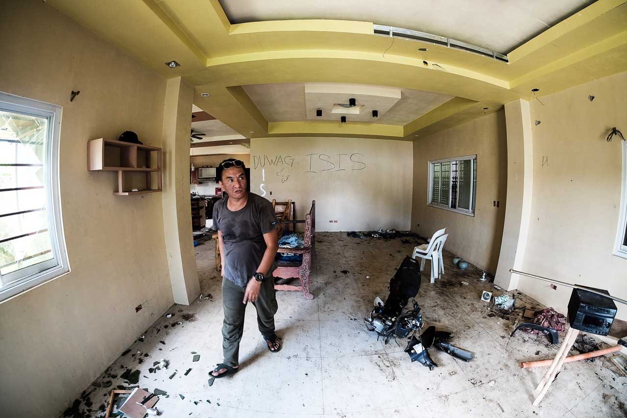 BACK TO ZERO. Farouk Usman Datumanong surveys what's left of his home, the fruit of decades of working overseas. While his house is intact, he says he has to start all over again Photo by Bobby Lagsa/Rappler
  