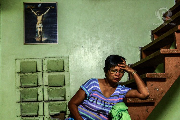 KRISTO'S WIFE. Nita Enaje rests on their house's staircase while his husband prints designs for the shirt of the volunteers.  