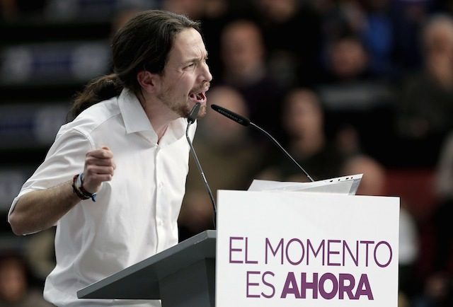 FIREBRAND. Podemos' general secretary and member of the European Parliament Pablo Iglesias makes a speech during a rally as part as their party's campaign 'Their hatred is our smile' at Fuente de San Luis sports pavilion in Valencia, eastern Spain, 25 January 2015. The placard reads 'The moment is now'. Juan Carlos Cardenas/EPA 
