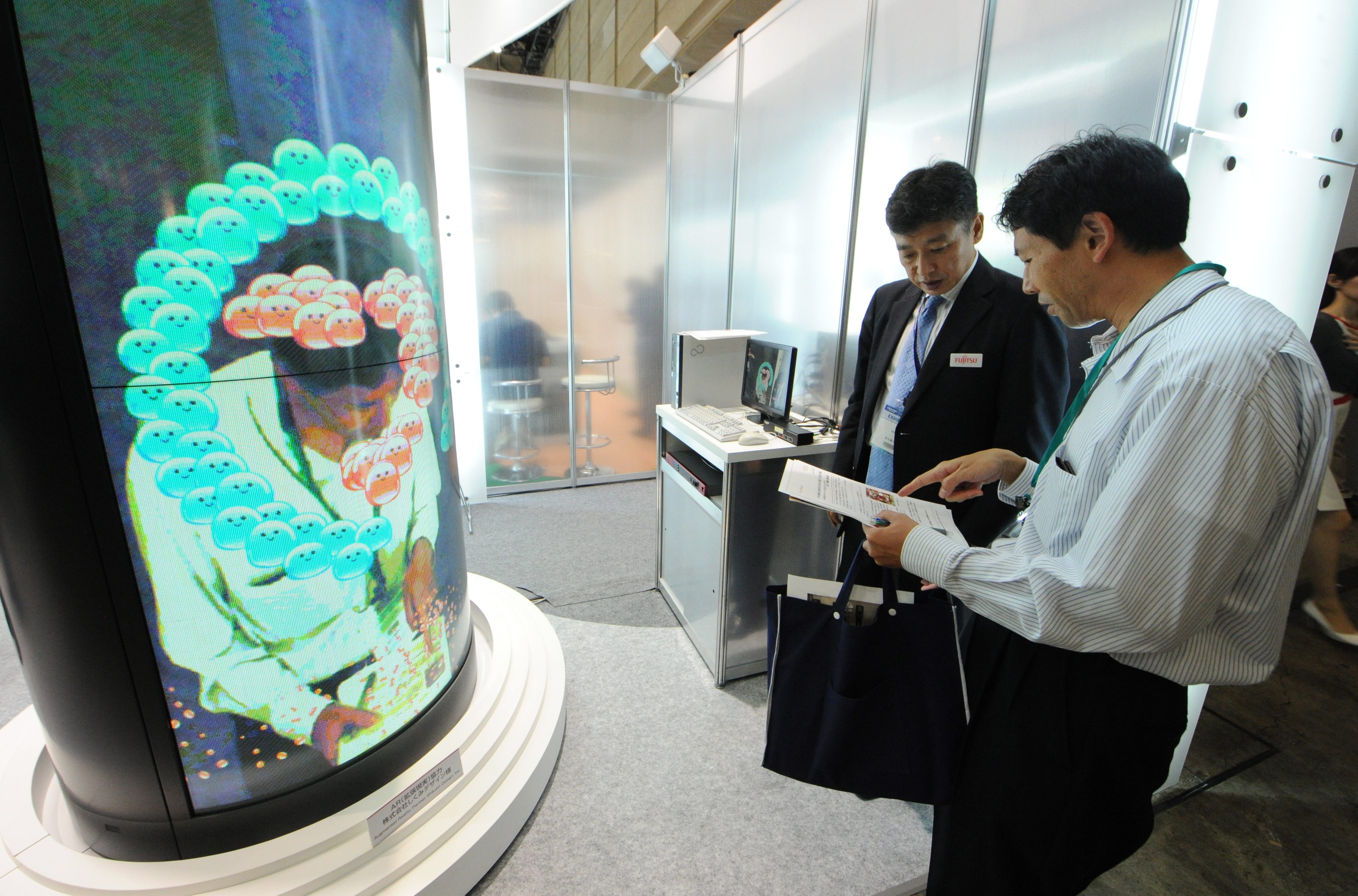 AUGMENTED REALITY. Visitors look at Fujitsu Corporation's AR technology at Japan CEATEC in Makuhari, Japan, October 5, 2010. File photo by Everett Kennedy Brown/EPA 