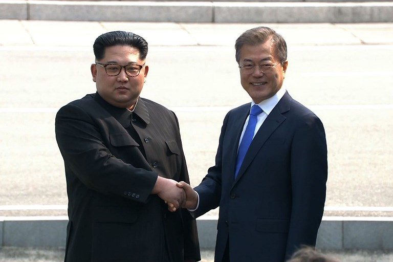 HISTORIC. This screen grab from the Korean Broadcasting System (KBS) taken on April 27, 2018 shows North Korea's leader Kim Jong-Un (L) and South Korea's President Moon Jae-in shaking hands at the Military Demarcation Line that divides their countries at Panmunjeom. File photo by Korean Broadcasting System/AFP 