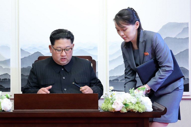 'A NEW HISTORY.' North Korea's leader Kim Jong Un (L) signs the guest book next to his sister Kim Yo Jong (R) during the Inter-Korean summit with South Korea's President Moon Jae-in at the Peace House building on the southern side of the truce village of Panmunjeom on April 27, 2018. AFP PHOTO / Korea Summit Press Pool 