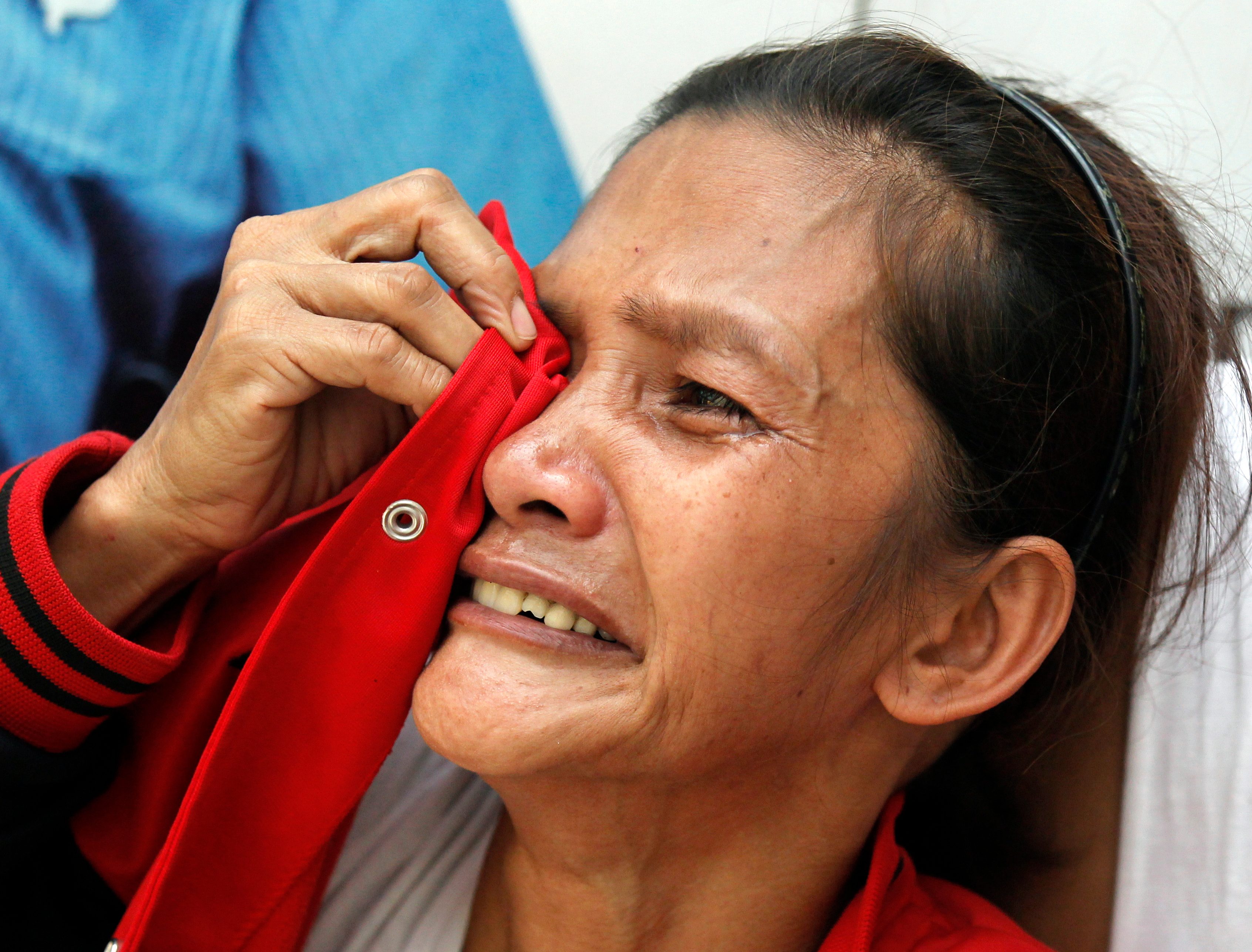 BENEFITS FOR FAMILIES. A Filipino relative of a missing factory worker reacts following a fire at a warehouse in Valenzuela City. The government promises to provide benefits to families of victims. EPA/FRANCIS R. MALASIG 
