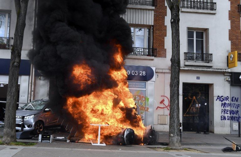 BURNING. A car and a motorbike burn during a demonstration on the sidelines of a march for the annual May Day workers' rally in Paris on May 1, 2018. Photo by Alain Jocard/AFP  