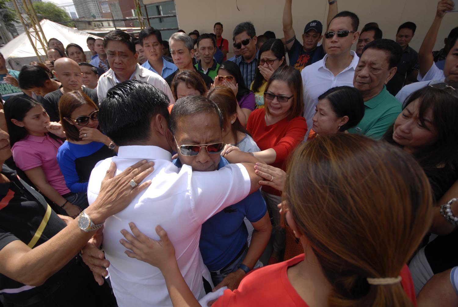 IN TEARS. Binay loyalists cry on July 1 as Makati Mayor Junjun Binay hugs his father after announcing before a crowd at the city hall quadrangle that he was stepping down as mayor and complying with the Ombudsman's preventive suspension order. Photo by Joel Leporada/Rappler  