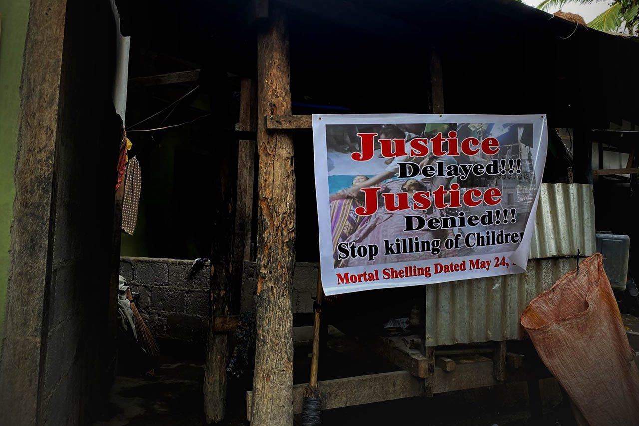JUSTICE FOR THE SLAIN. Neighbors of the slain sisters in Barangay Kitango post calls for justice outside their houses. Photo by Taj Basman 