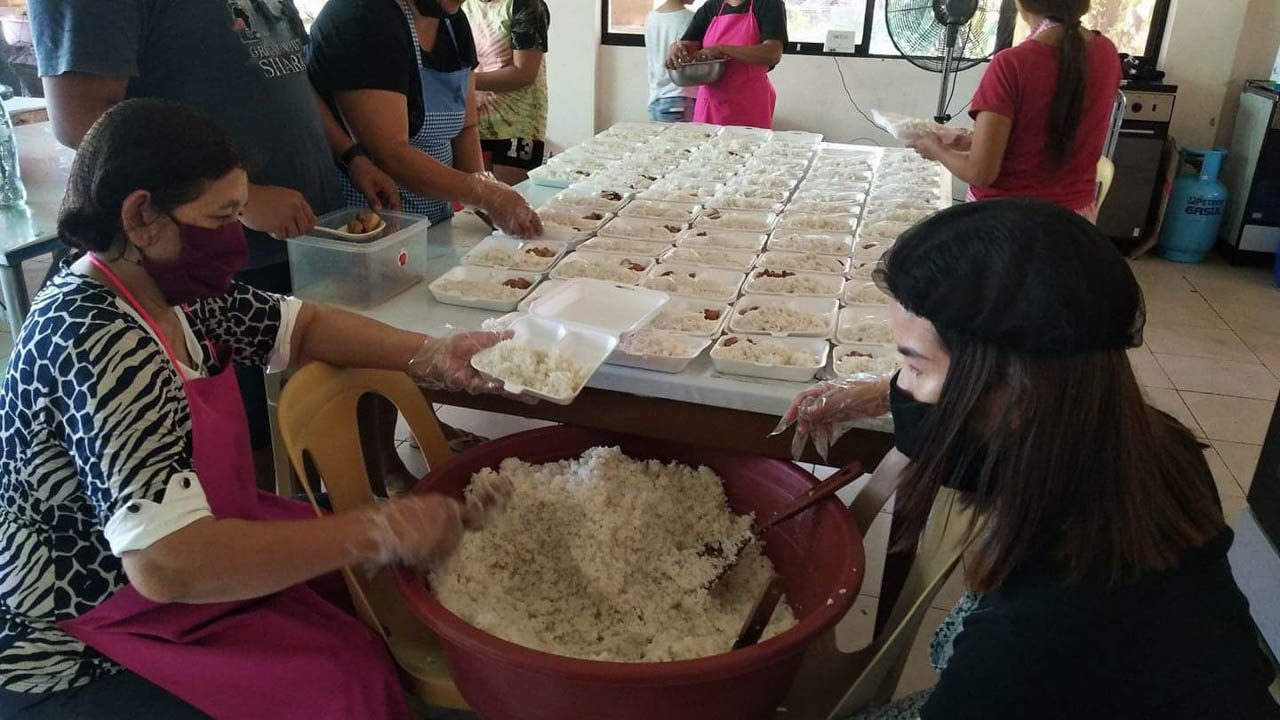 FOOD SERVICE. Volunteer cooks of the Himamaylan City satellite campus of Iloilo-based West Visayas State University help pack meals for distribution to the cityâs front liners. Photo by Genesis Camarista  