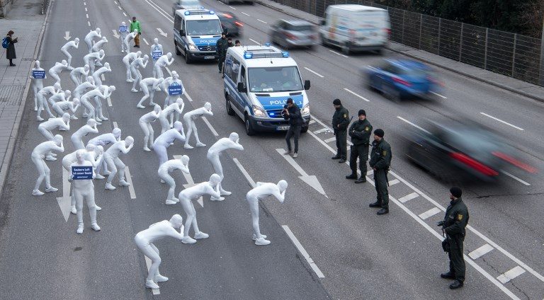 HEALTH PROTEST. Greenpeace activists wear white morphsuits as they stage an action against particulate matter and health burden caused by diesel exhaust on February 19, 2018, in Stuttgart, Germany. Photo by Sebastian Gollnow/DPA/AFP 