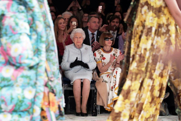 LONDON FASHION WEEK. Britain's Queen Elizabeth II, accompanied by British-American journalist and editor Anna Wintour (R), views British designer Richard Quinn's runway show before presenting him with the inaugural Queen Elizabeth II Award for British Design, during her visit to London Fashion Week's BFC Show Space in London on February 20, 2018. Photo by Yui Mok/AFP/Pool  