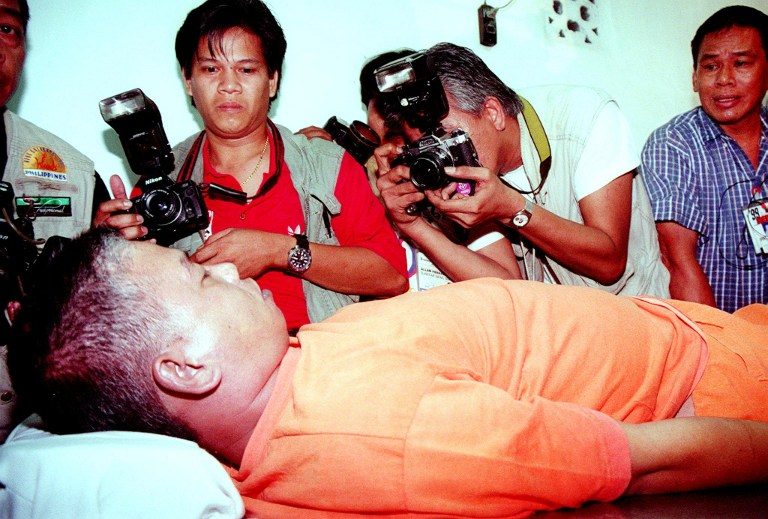 DEATH VIA LETHAL INJECTION. Photographers take pictures of the body of death convict Leo Echegaray after his body was transferred to a funeral morgue near Manila on February 5, 1999. File photo by Alex de la Rosa/AFP 