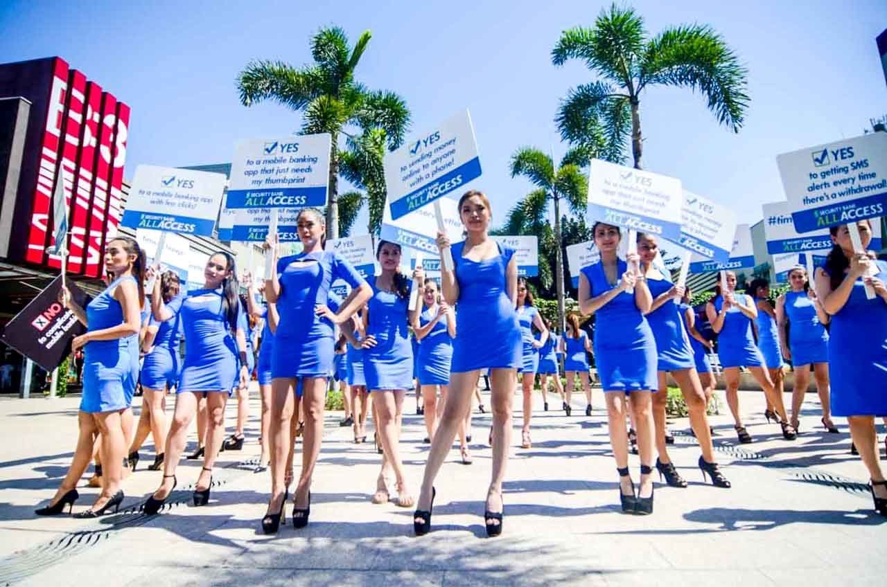 ARMY OF BLUE. Fifty models hold up placards in the middle of High Street, Bonifacio Global City.  
