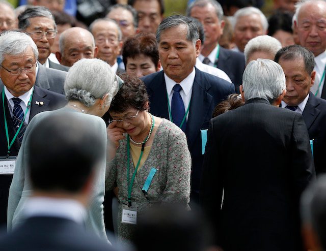 'ACHIEVING PEACE.' Japan's Emperor Akihito (R) and Empress Michiko (L) comfort relatives of fallen WWII Japanese soldiers during a ceremony at a mass grave on a mountain top in the town of Lumban, Laguna province, Philippines, January 29, 2016. Photo by Francis R. Malasig/EPA  