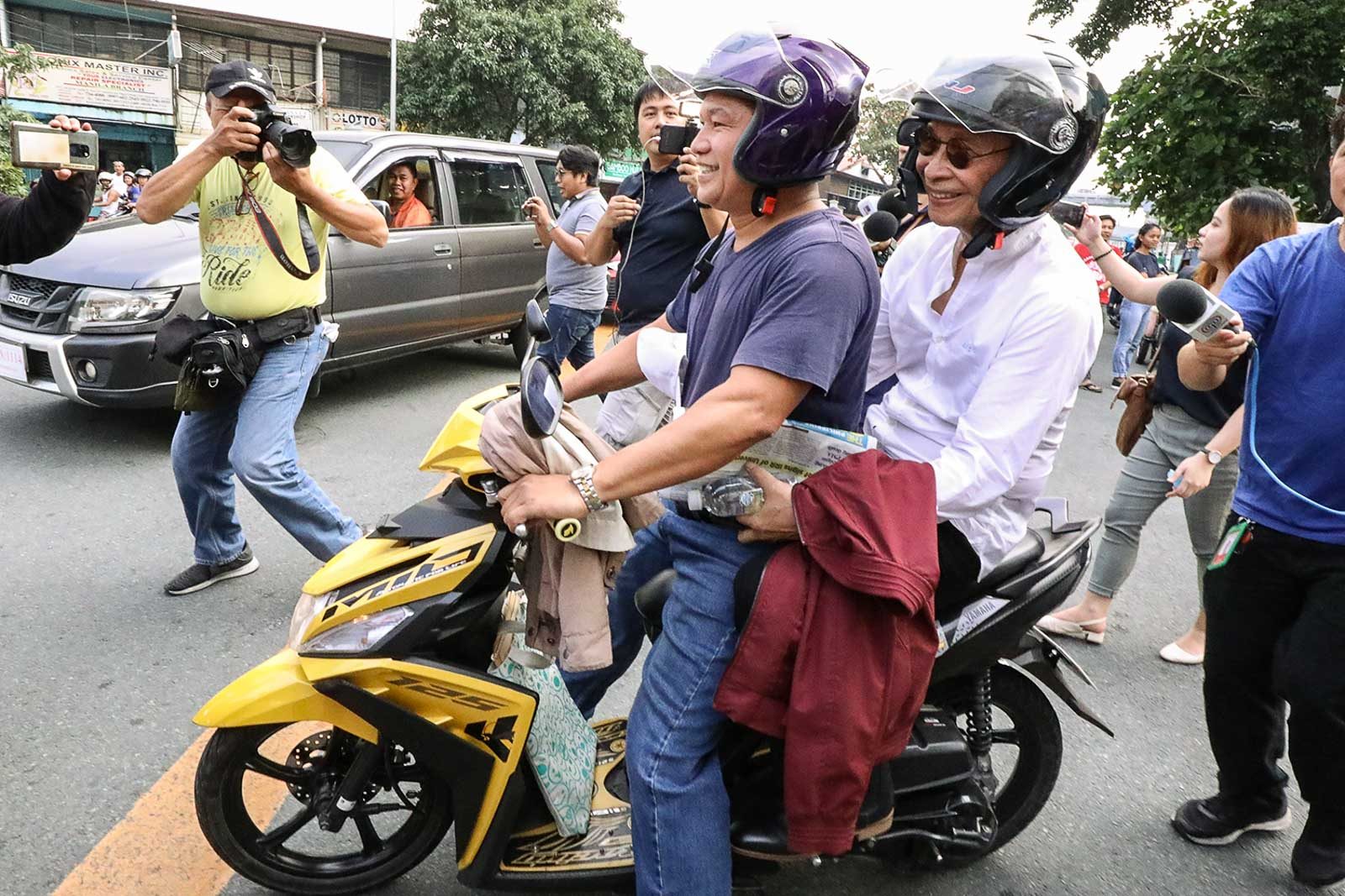 BIKE RIDE. Spokeperson Salvador Panelo gets on a motor bike ride for the last leg of his commute to Malacangg on October 11, 2019. Photo by Darren Langit/Rappler  