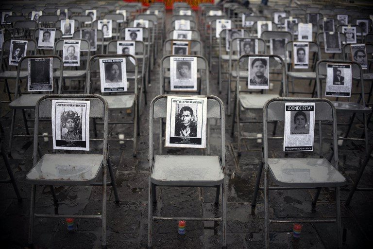 IN MEMORIAM. Portraits of victims of forced disappearances hang on empty chairs during the ceremony to commemorate the National Day of the Victims of Enforced Disappearances at Constitution Square in Guatemala City on June 21, 2017. Photo by Johan Ordonez/AFP   