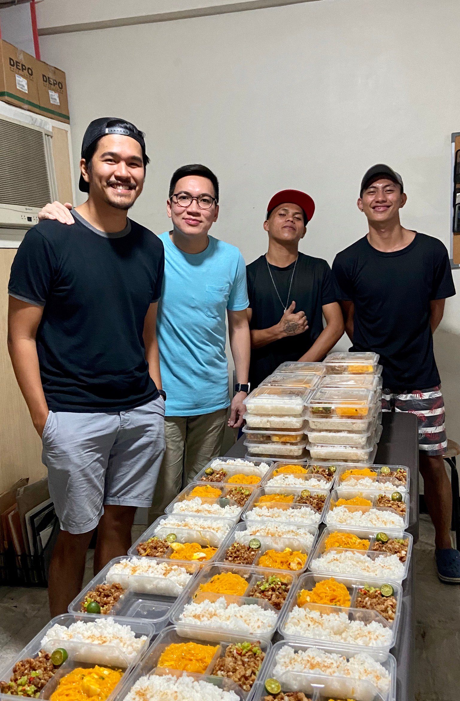 FOOD ON THE WAY. Friends Louis Banzon and Gab Viernes, and Gab's staff Lance Bellen and Cobe Bryant Real prepare food packs for frontliners at Quezon City General Hospital. Photo courtesy of Louis Banzon 