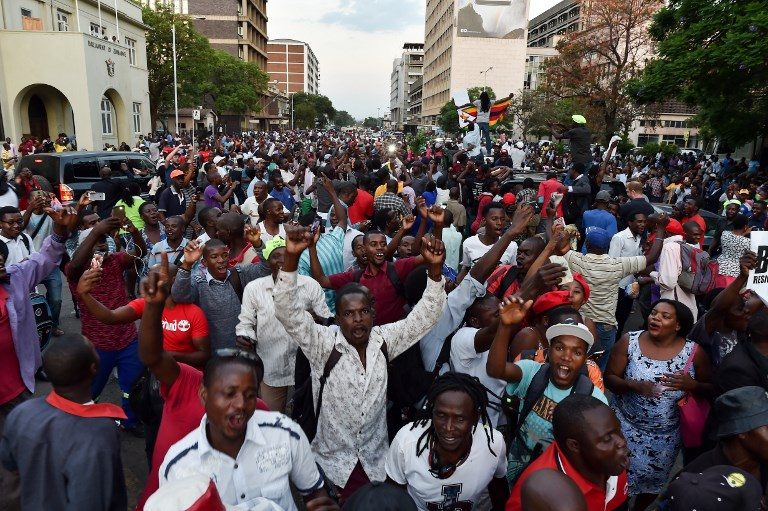 STREET PARTY. People celebrate in the streets of Harare, after the resignation of Zimbabwe's president Robert Mugabe on November 21, 2017.  Tony Karumba/AFP 