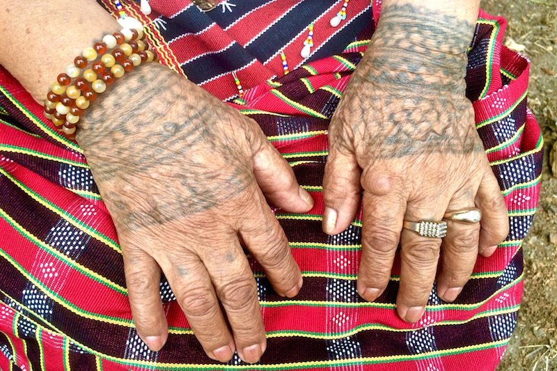 Tattoo patterns are withered with time on Lasoy’s hands
  