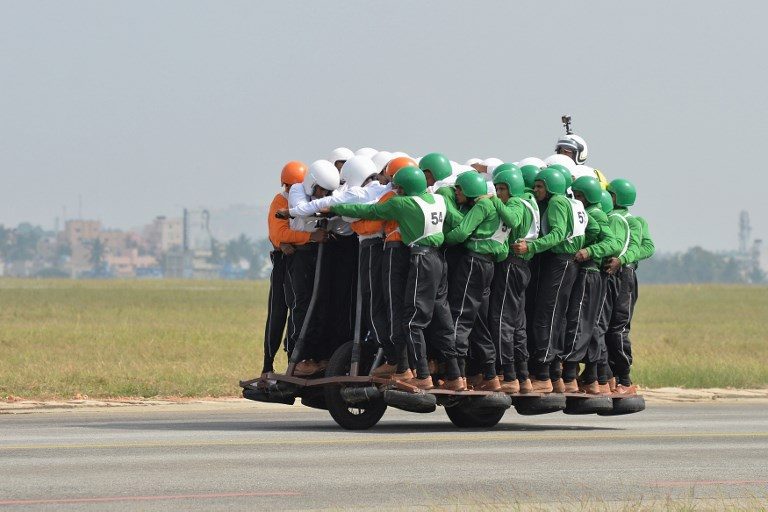 WORLD RECORD FEAT. Members of the Tornadoes motorcycle display team of the Army Service Corps (ASC) on the final run for the World Record for carrying 58 men on a single 500 cc motorcycle in Bangalore on November 19, 2017. Photo by Manjunath Kiran/AFP 