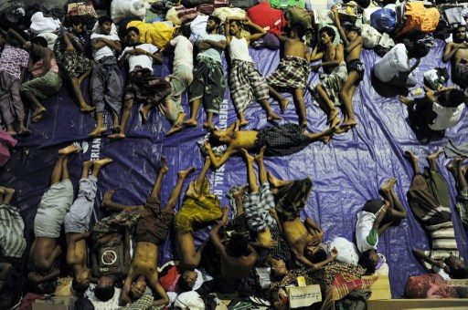 CRAMPED. A group of rescued mostly Rohingya migrants from Myanmar and Bangladesh, sleep at a government sports auditorium in Lhoksukon in Aceh province on May 12, 2015. Chaideer Mahyuddin/AFP PHOTO   