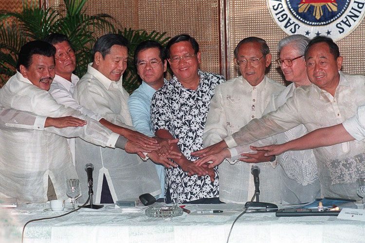Philippines president Fidel Ramos (3rd R), four presidential candidates and top officials join hands for a group picture after meeting in Malacanang Palace 10 May in Manila where they discussed the forthcoming election. From (L) are Vice President Joseph Estrada, former defense secretary Renato de Villa, Senate President Neptali Gonzales, candidate for vice president Kit Tatad, Senator Raul Roco, Ramos, Election Chairman Bernardo Pardo and House Speaker Jose de Venecia. Estrada and de Venecia the chief rivals, de Villa and Roco are among the 11 presidential candidates in the 11 May elections. AFP PHOTO/ROMEO GACAD 