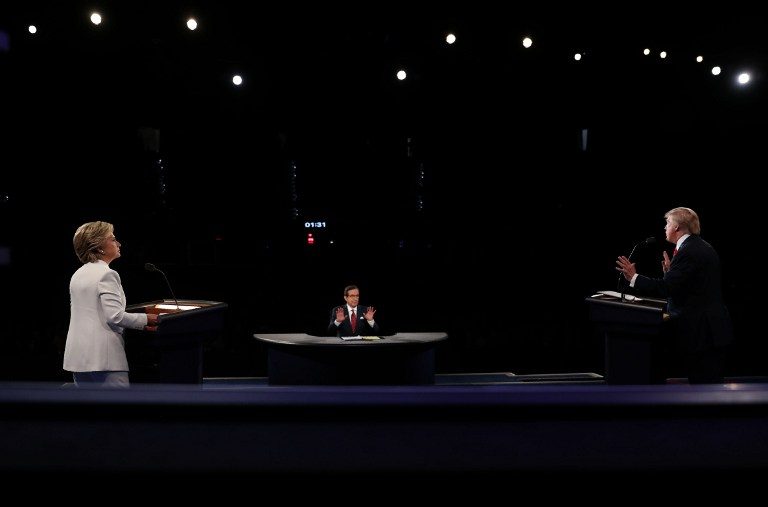 Democratic nominee Hillary Clinton (L) and Republican nominee Donald Trump take part in the final presidential debate at the Thomas & Mack Center on the campus of the University of Las Vegas in Las Vegas, Nevada on October 19, 2016. Joe Raedle/Pool/AFP 
