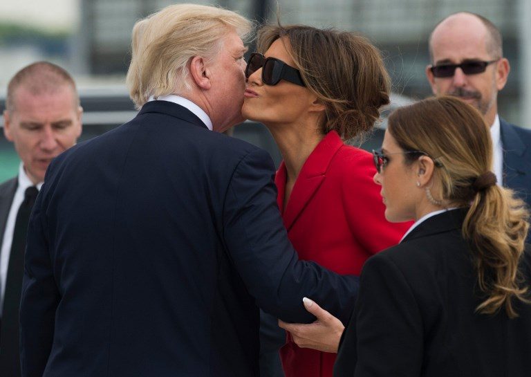 'FRENCH KISS'. President Donald Trump kisses First Lady Melania Trump after disembarking form Air Force One upon arrival at Paris Orly airport on July 13, 2017. Photo by Saul Loeb/AFP   