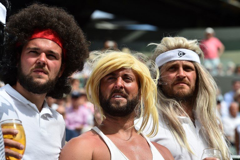 WIMBLEDON. Tennis fans wearing wigs resembling legendary players watch Spain's Rafael Nadal play against Luxembourg's Gilles Muller during their men's singles 4th round match on the 7th day of the 2017 Wimbledon Championships at The All England Lawn Tennis Club in London on July 10, 2017. Photo by Glyn Kirk/AFP   
