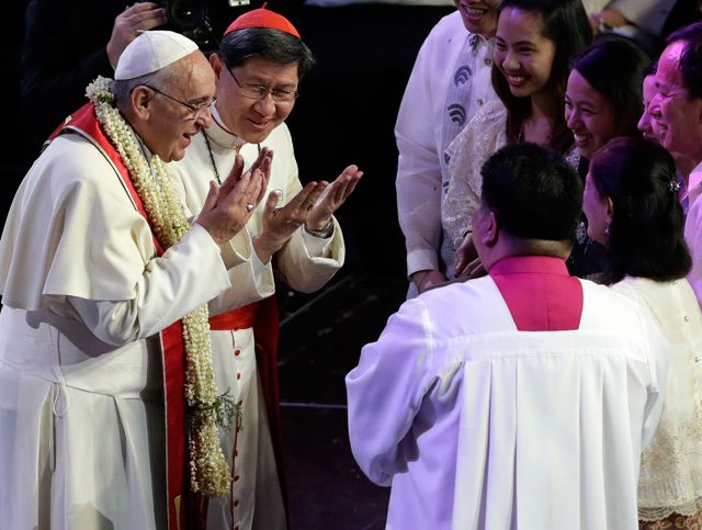 Pope Francis interacts thru a sign language to  Filipino parents with disabilities during a meeting with families at the MOA Arena. Photo by Francis Malasig/EPA   