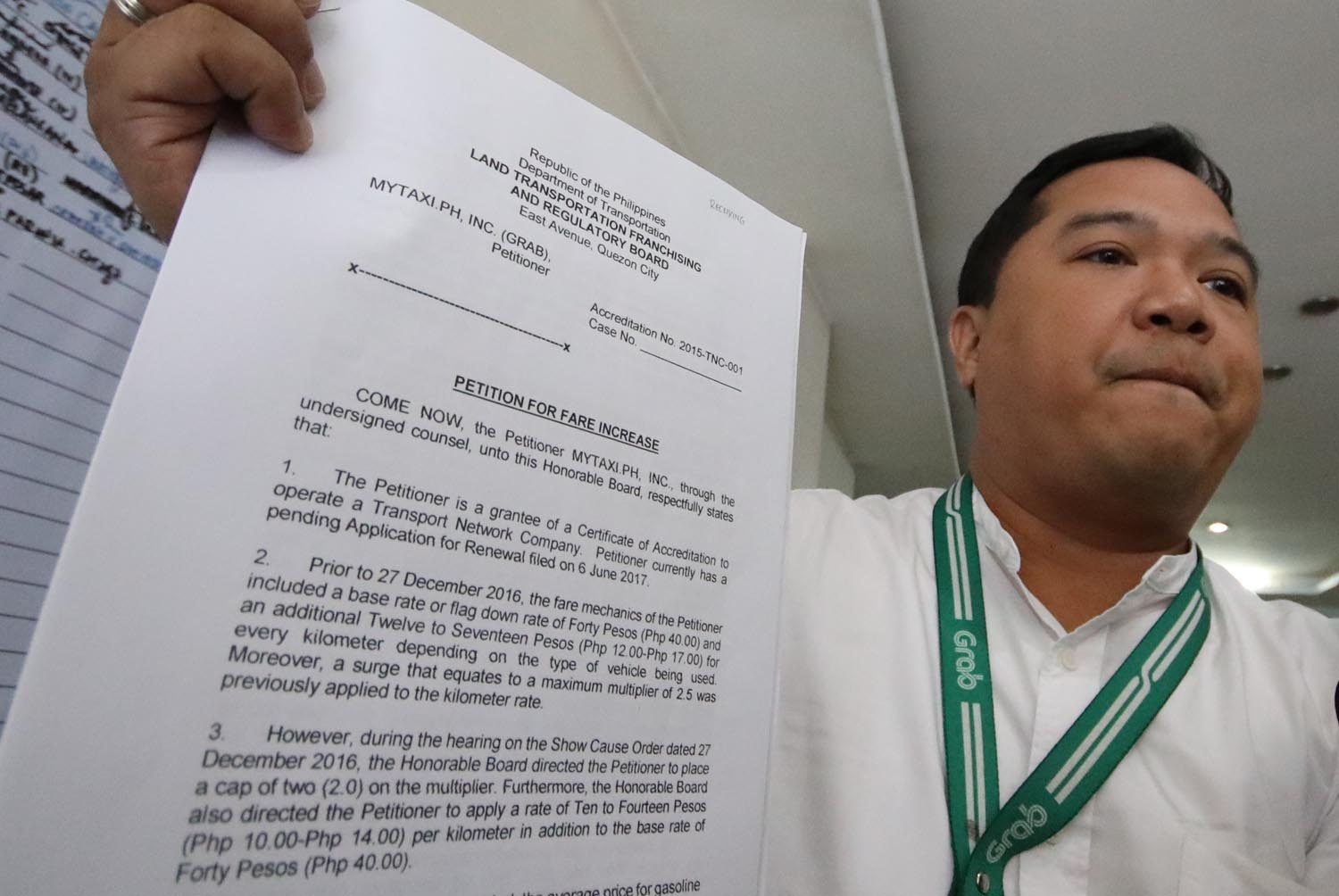 FILED. Leo Gonzales, Grab Philippines Public Affairs Office Head, show a copy of a petition for fare hike he filed at the LTFRB on Friday. Photo by Darren Langit/Rappler 