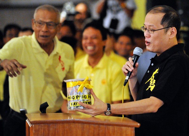 DONATION. Aquino speaks after receiving donations from supporters in a symbolic gesture to jumpstart his 2010 presidential candidacy. File photo by Ted Aljibe/AFP  