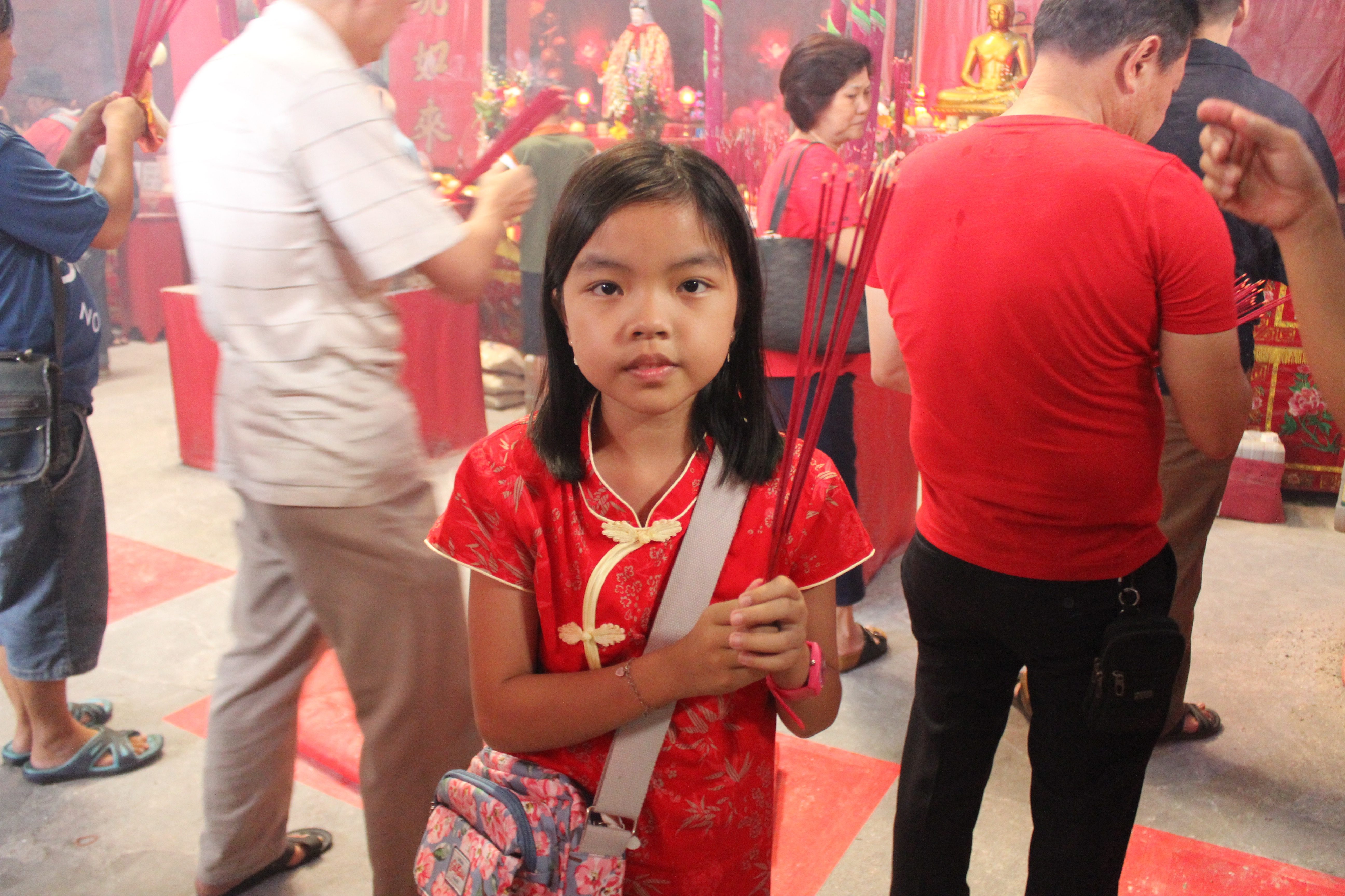 YOUNG GIRL. Temple goers pray for good fortune and health in the New Year. Photo by Han Nguyen

 