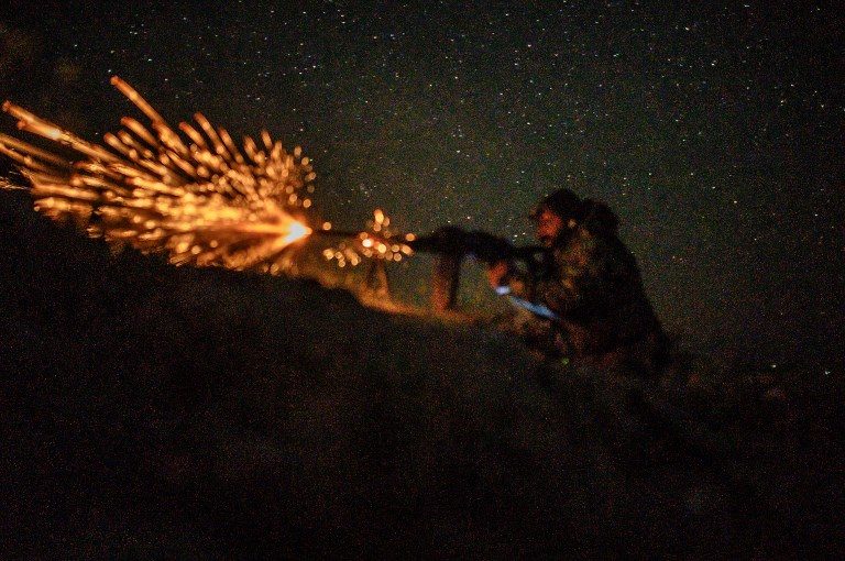 TIME'S UP. A fighter with the Syrian Democratic Forces fires a machine gun  in the eastern Syrian province of Deir Ezzor outside the Islamic State group's embattled holdout of Baghouz, on March 11, 2019. Photo by Bulent Kilic/AFP  
