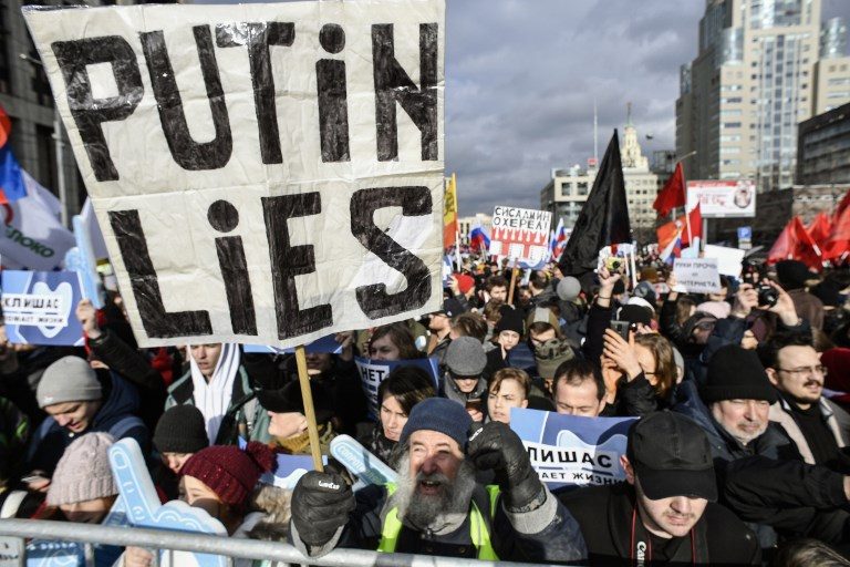 LIES. A protester holds a placard reading 'Putin lies' during an opposition rally in central Moscow, on March 10, 2019, to demand internet freedom in Russia. Photo by Alexander Nemenov/AFP 