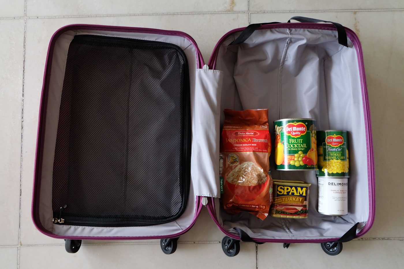 BARBELL SUBSTITUTE. Fill up a luggage with canned goods and other things for a substitute to the bigger gym equipment. Photo by Beatrice Go/Rappler 