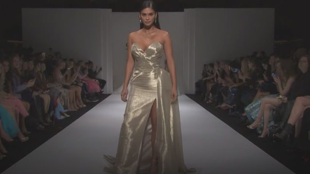 FIRST DRESS. Pia comes out in a shiny strapless gown with slit  