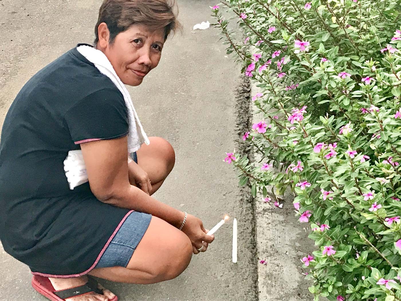 HOPE STILL REMAINS. Analyn Pajares, 43, is a resident of Barangay 88 San Jose. She lights a candle for her sibling who has yet to be found since Super Typhoon Yolanda. She has not lost hope that someday, her sibling will come home. Photo by Jene-Anne Pangue  