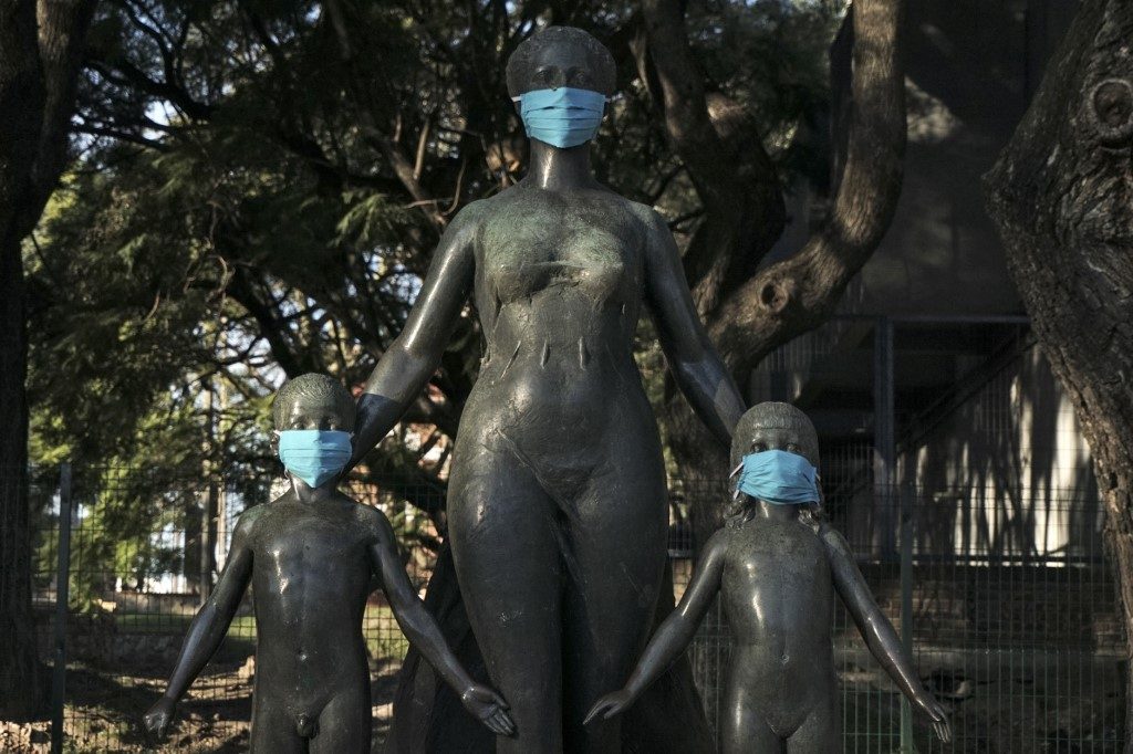 MASKED. A sculpture in honor of Spanish-born Uruguayan teacher Enriqueta Compte y Rique is seen with face masks at a park in Montevideo on June 3, 2020. Photo by Eitan Abramovich/AFP 