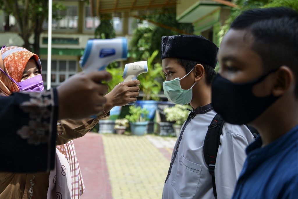 Indonesia posts record virus infections as restrictions eased